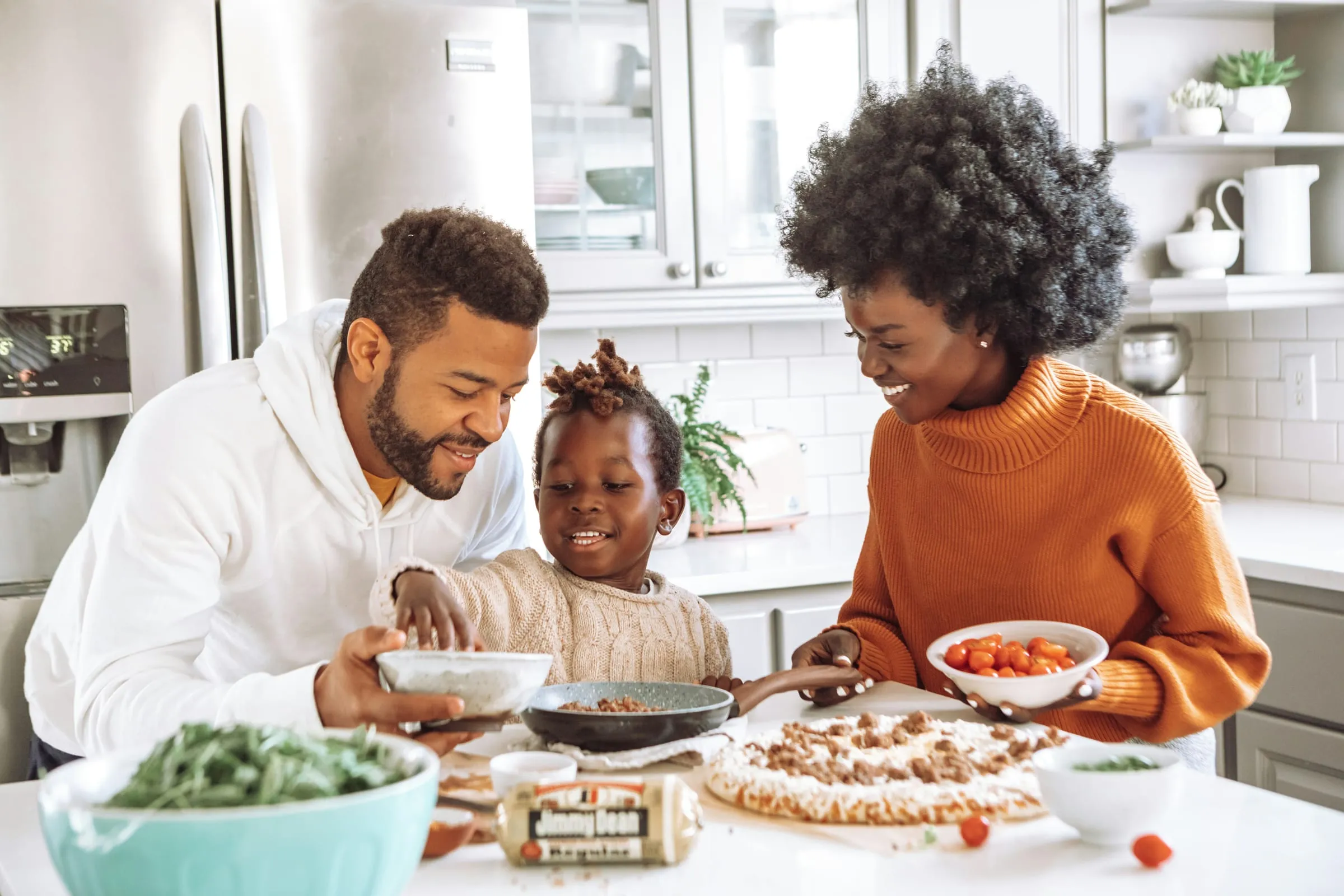 A family cooking a meal together in their kitchen