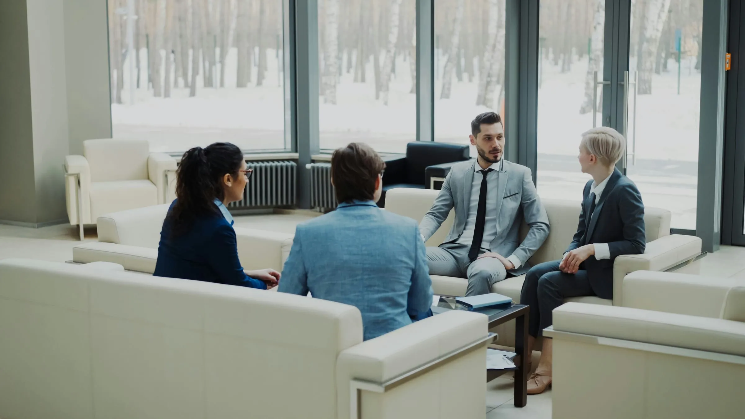 A group of professionals talking in a lounge