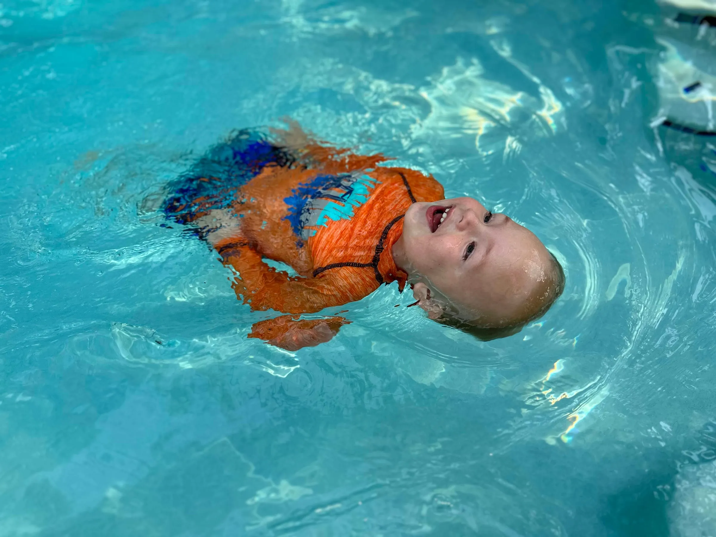 A toddler swimming in a pool