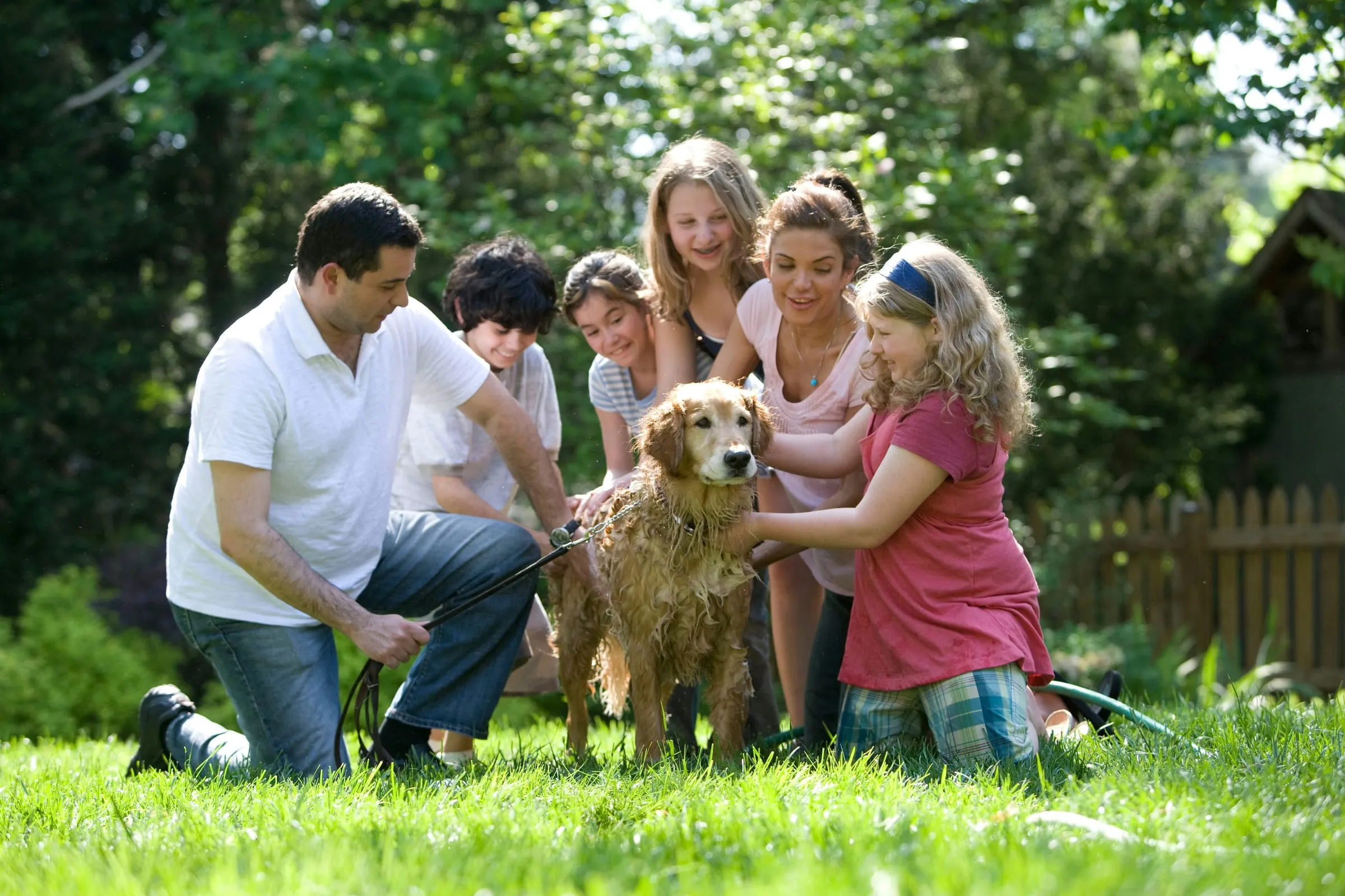 A family relaxing outdoors with their dog
